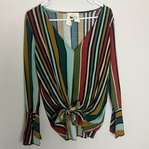 Medium size blouse I bought at a boutique, it has a small whole in the wrist